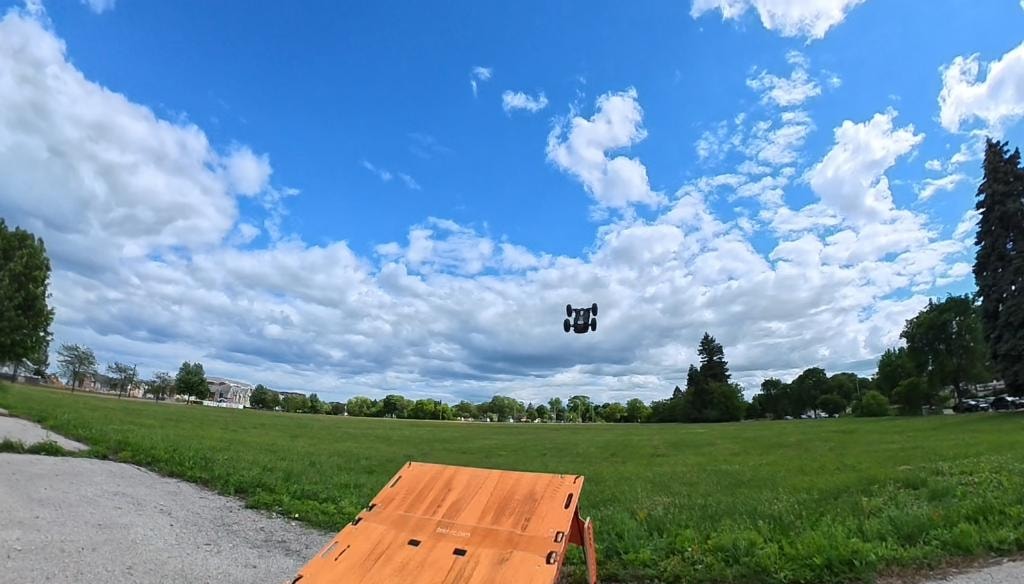 RC car airborne over a park ramp