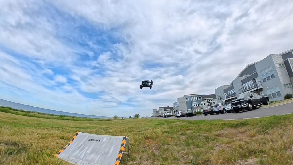 RC buggy launching off a ramp into the sky