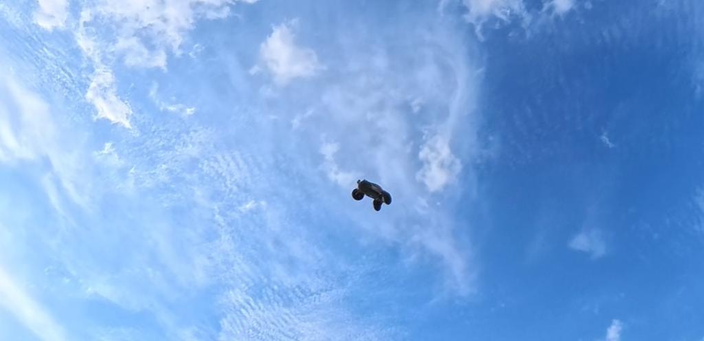 RC car silhouetted against a dramatic cloudy sky